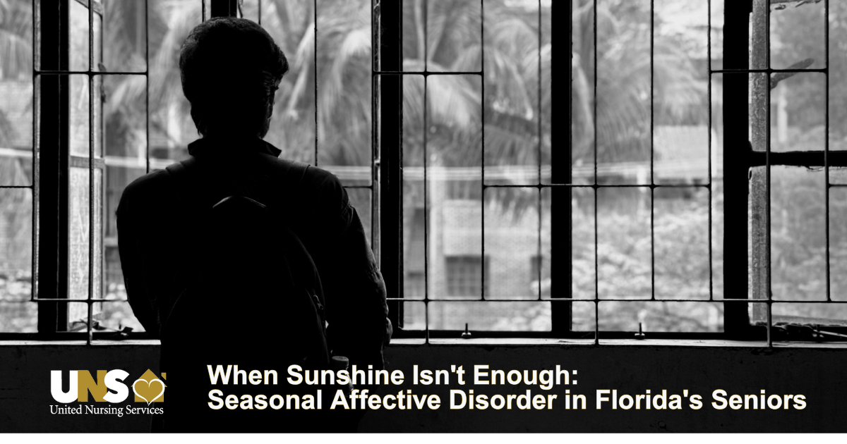 A senior in Palm Beach County has her back to us as she looks out of her window. The image is dark with the sunlight coming through the window. older adults who live alone or in assisted-living settings may need a Home Health Care in Palm Beach visit to make sure they are safe.